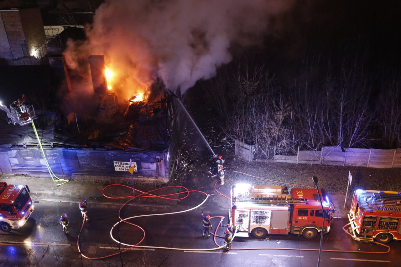 Crafting Captivating Headlines: Your awesome post title goes here Firefighters battle a blaze at night using fire hoses and trucks in an urban setting.