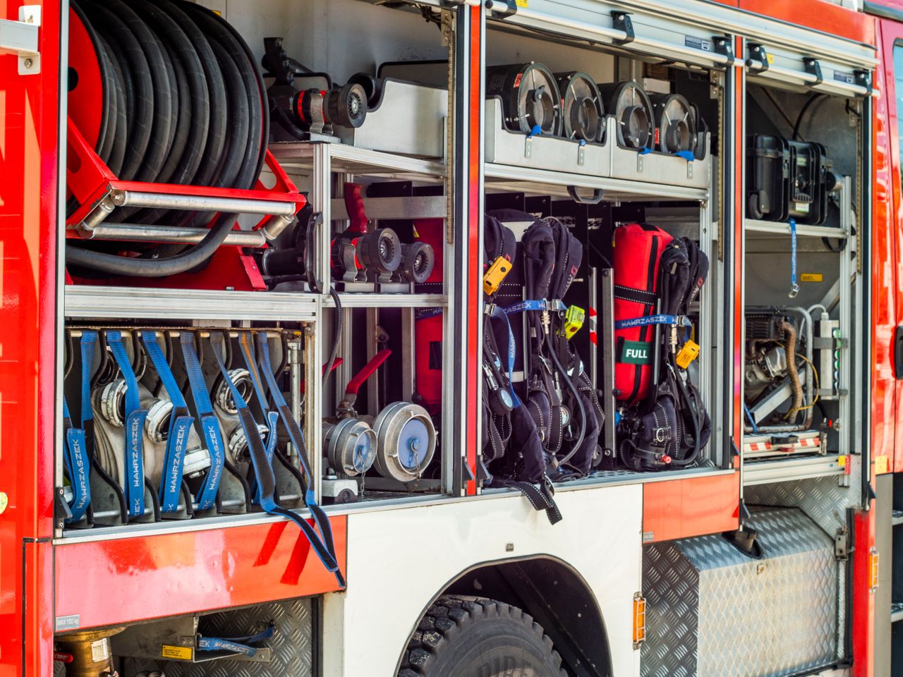 Mastering the First Impression: Your intriguing post title goes here Close-up view of fire truck equipment storage showcasing hoses, tools, and gear.